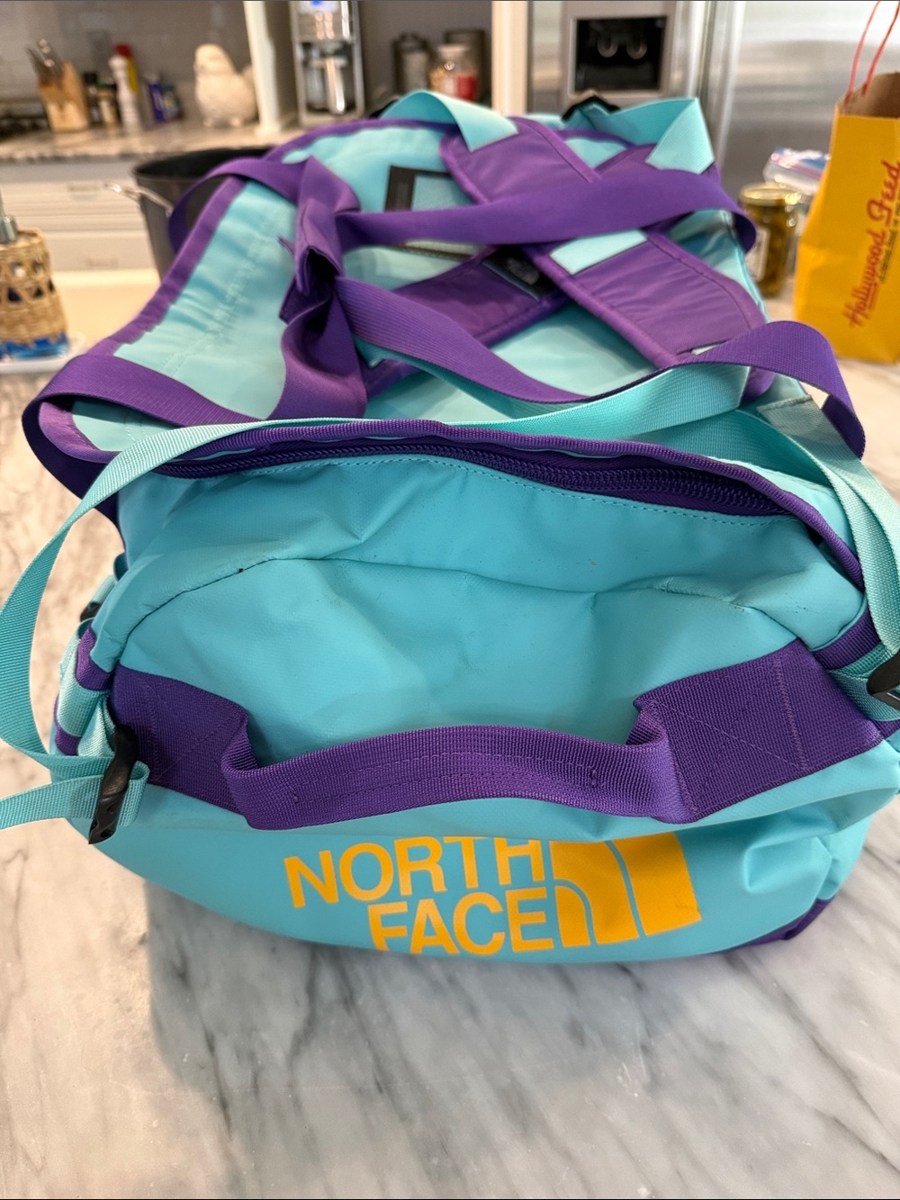 The North Face Teal Travel Duffel with Purple Straps and Yellow Logo